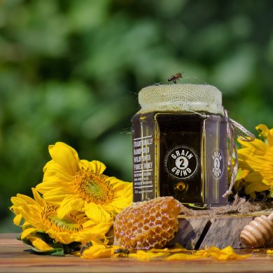 Hohey in glass jars and western honey bee. Honey Bee on nature background .